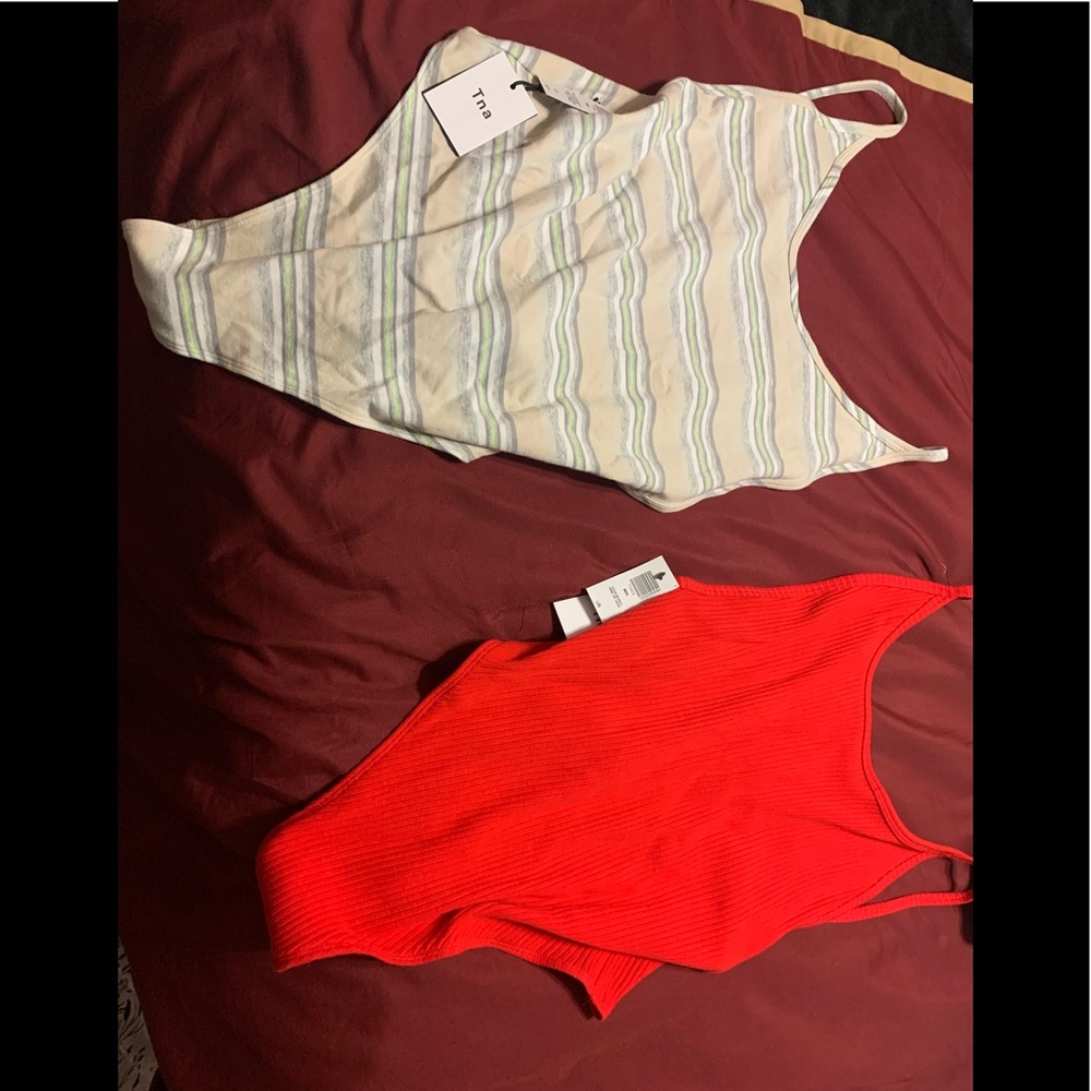 Two TNA Cozumel bodysuits